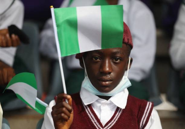 A Schoolboy display the Nigerian flag at the Eagles Square in Abuja, Nigeria during the country 61st Independence Celebration on October 1, 2021. Nigeria is holding scaled-down celebrations due to high level of insecurity to commemorate over six decades since it gained self-rule from Britain in 1960. (Photo by Kola Sulaimon / AFP) (Photo by KOLA SULAIMON/AFP via Getty Images)