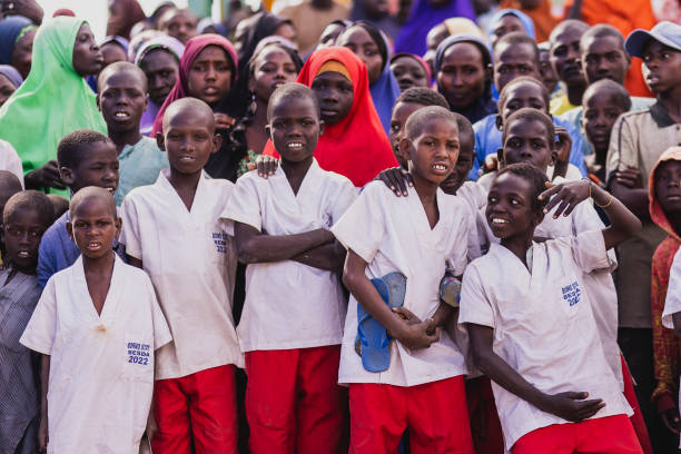 NGARANNAM, NIGERIA - DECEMBER 19: Boys are pictured in the small village, that was destroyed by Boko Haram and rebuilt with german capital on December 19, 2022 in Ngarannam, Nigeria. The region in the north east of Nigeria suffered from the terror organization Boko Haram, that kidnapped 276 schoolgirls in April 2014. (Photo by Florian Gaertner/Photothek via Getty Images)